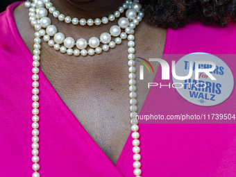 A woman wears a button that says ''Teachers for Harris Walz'' at a Get Out the Vote event in Harrisburg, Pennsylvania, United States, on Nov...