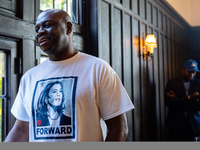 A supporter of Vice President Kamala Harris wears a shirt with her picture on it at a Get Out the Vote event in Harrisburg, Pennsylvania, Un...