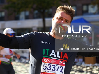 Alan Clusaz of Italy poses for a photo at mile 16 as he heads up First Avenue during the 2024 New York City Marathon in New York, N.Y., on N...