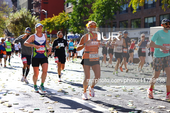 Runner Alexis Herron of the United States smiles at the camera as she heads up First Avenue during the 2024 New York City Marathon in New Yo...