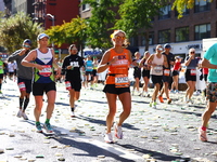 Runner Alexis Herron of the United States smiles at the camera as she heads up First Avenue during the 2024 New York City Marathon in New Yo...