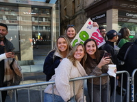 Crowds hold up signs and watch New York City marathon runners as they race up First Avenue in the Upper East Side neighborhood of New York,...