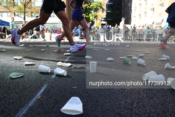 A checkered cab drives Grand Marshall Olympic champion Gabby Thomas up First Avenue during the New York City Marathon in New York City, Unit...