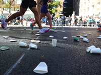 A checkered cab drives Grand Marshall Olympic champion Gabby Thomas up First Avenue during the New York City Marathon in New York City, Unit...