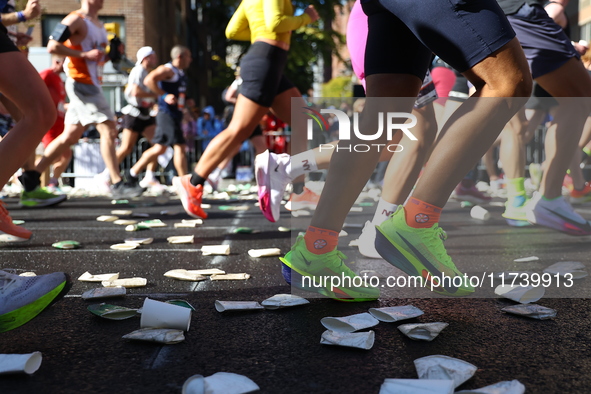 A checkered cab drives Grand Marshall Olympic champion Gabby Thomas up First Avenue during the New York City Marathon in New York City, Unit...