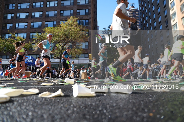 A checkered cab drives Grand Marshall Olympic champion Gabby Thomas up First Avenue during the New York City Marathon in New York City, Unit...