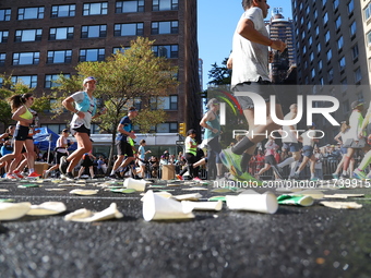 A checkered cab drives Grand Marshall Olympic champion Gabby Thomas up First Avenue during the New York City Marathon in New York City, Unit...