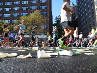 A checkered cab drives Grand Marshall Olympic champion Gabby Thomas up First Avenue during the New York City Marathon in New York City, Unit...