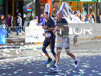 Two runners from France with an interesting headdress run up First Avenue during the 2024 New York City Marathon in New York, N.Y., on Novem...