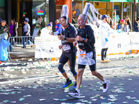 Two runners from France with an interesting headdress run up First Avenue during the 2024 New York City Marathon in New York, N.Y., on Novem...