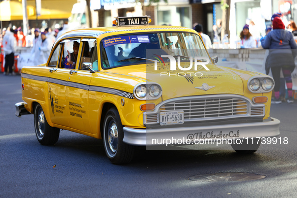 A checkered cab drives Grand Marshall Olympic champion Gabby Thomas up First Avenue during the New York City Marathon in New York City, Unit...