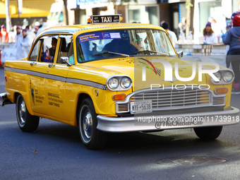 A checkered cab drives Grand Marshall Olympic champion Gabby Thomas up First Avenue during the New York City Marathon in New York City, Unit...