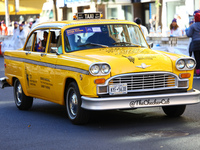 A checkered cab drives Grand Marshall Olympic champion Gabby Thomas up First Avenue during the New York City Marathon in New York City, Unit...