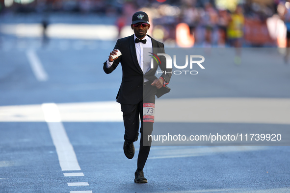 Hakeem Olajuwan Adewale of Germany heads up First Avenue in a suit during the 2024 New York City Marathon in New York, N.Y., on November 3,...