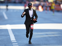 Hakeem Olajuwan Adewale of Germany heads up First Avenue in a suit during the 2024 New York City Marathon in New York, N.Y., on November 3,...