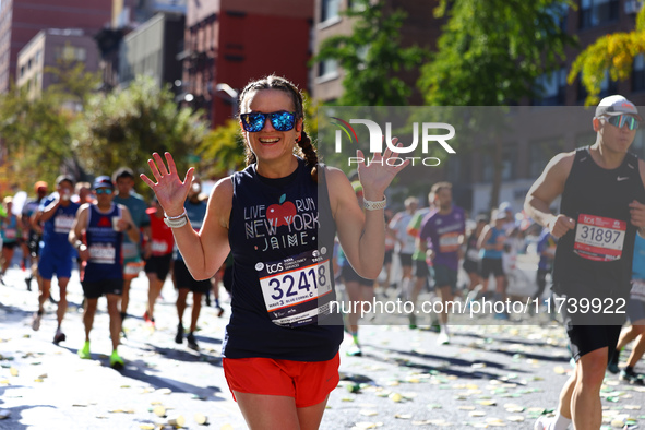 Runner Jaime Vining smiles as she heads up First Avenue during the 2024 New York City Marathon in New York, N.Y., on November 3, 2024. 