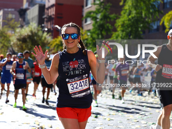 Runner Jaime Vining smiles as she heads up First Avenue during the 2024 New York City Marathon in New York, N.Y., on November 3, 2024. (