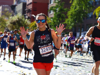 Runner Jaime Vining smiles as she heads up First Avenue during the 2024 New York City Marathon in New York, N.Y., on November 3, 2024. (