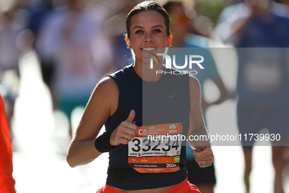 Runner Kallie Donley of the United States gives a thumbs up as she heads up First Avenue during the 2024 New York City Marathon in New York,...