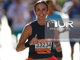 Runner Kallie Donley of the United States gives a thumbs up as she heads up First Avenue during the 2024 New York City Marathon in New York,...