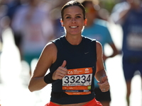 Runner Kallie Donley of the United States gives a thumbs up as she heads up First Avenue during the 2024 New York City Marathon in New York,...