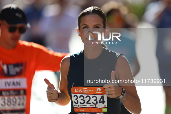 Runner Kallie Donley of the United States gives a thumbs up as she heads up First Avenue during the 2024 New York City Marathon in New York,...