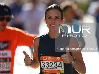 Runner Kallie Donley of the United States gives a thumbs up as she heads up First Avenue during the 2024 New York City Marathon in New York,...