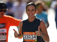 Runner Kallie Donley of the United States gives a thumbs up as she heads up First Avenue during the 2024 New York City Marathon in New York,...