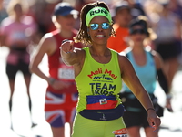 Melissa Mondesir of the United States gestures towards the camera as she heads up First Avenue during the 2024 New York City Marathon in New...