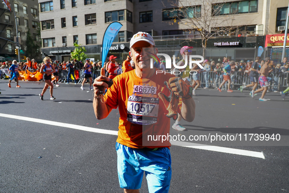 Despite running 16 miles in three boroughs, Staten Islander Pete Weinman finds a smile while running up First Avenue during the New York Cit...