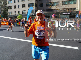 Despite running 16 miles in three boroughs, Staten Islander Pete Weinman finds a smile while running up First Avenue during the New York Cit...