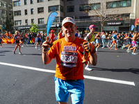 Despite running 16 miles in three boroughs, Staten Islander Pete Weinman finds a smile while running up First Avenue during the New York Cit...