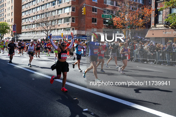 Runners trudge up First Avenue at Mile 16 of the New York City Marathon in New York City, United States, on November 3, 2024. 