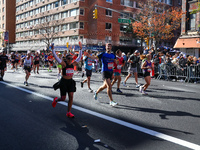 Runners trudge up First Avenue at Mile 16 of the New York City Marathon in New York City, United States, on November 3, 2024. (