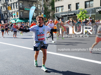 Runners trudge up First Avenue at Mile 16 of the New York City Marathon in New York City, United States, on November 3, 2024. (