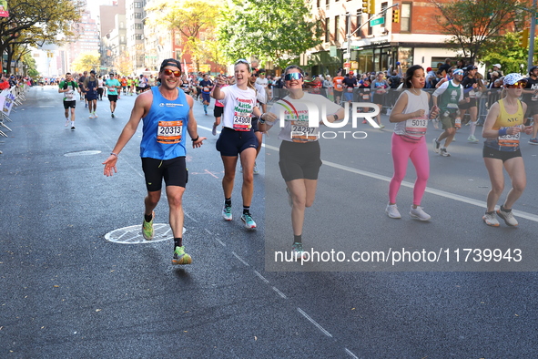 Runners trudge up First Avenue at Mile 16 of the New York City Marathon in New York City, United States, on November 3, 2024. 