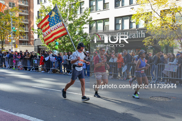 Runners trudge up First Avenue at Mile 16 of the New York City Marathon in New York City, United States, on November 3, 2024. 