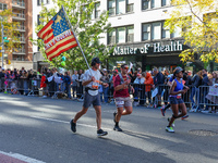 Runners trudge up First Avenue at Mile 16 of the New York City Marathon in New York City, United States, on November 3, 2024. (