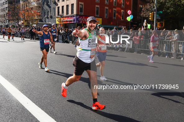 Runners trudge up First Avenue at Mile 16 of the New York City Marathon in New York City, United States, on November 3, 2024. 