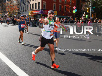 Runners trudge up First Avenue at Mile 16 of the New York City Marathon in New York City, United States, on November 3, 2024. (