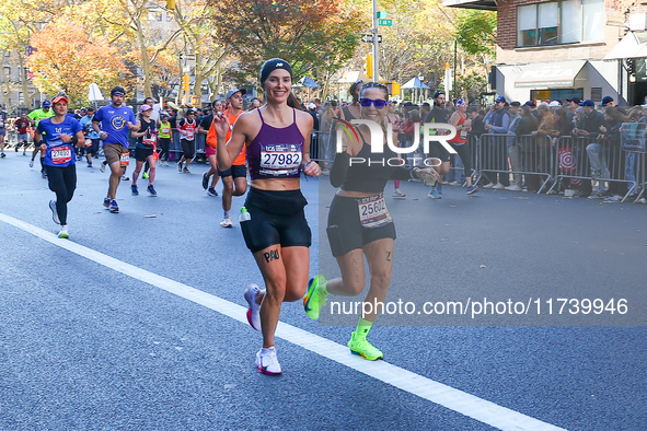 Runners trudge up First Avenue at Mile 16 of the New York City Marathon in New York City, United States, on November 3, 2024. 