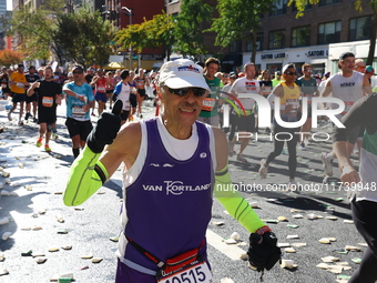 Runners trudge up First Avenue at Mile 16 of the New York City Marathon in New York City, United States, on November 3, 2024. (