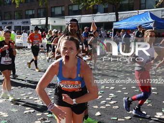 Runners trudge up First Avenue at Mile 16 of the New York City Marathon in New York City, United States, on November 3, 2024. (