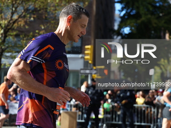 Runners trudge up First Avenue at Mile 16 of the New York City Marathon in New York City, United States, on November 3, 2024. (