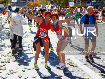 Runners Michelle Douglas and Michelle Richards of the United States pose for a photo as they head up First Avenue during the 2024 New York C...