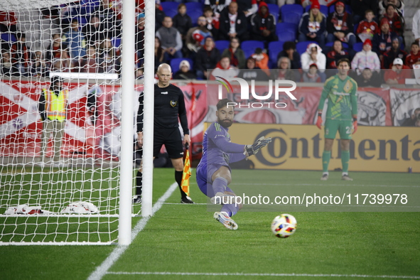 New York Red Bulls goalkeeper Carlos Coronel makes a penalty kick save to eliminate the defending MLS Cup champion Columbus Crew in Harris,...