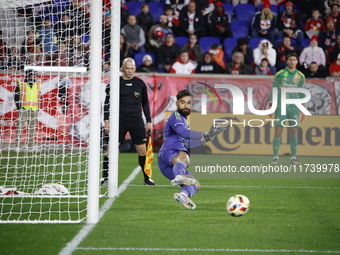 New York Red Bulls goalkeeper Carlos Coronel makes a penalty kick save to eliminate the defending MLS Cup champion Columbus Crew in Harris,...