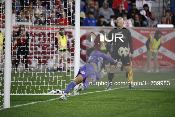 New York Red Bulls goalkeeper Carlos Coronel makes a penalty kick save to eliminate the defending MLS Cup champion Columbus Crew in Harris,...