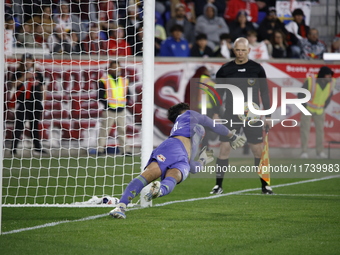 New York Red Bulls goalkeeper Carlos Coronel makes a penalty kick save to eliminate the defending MLS Cup champion Columbus Crew in Harris,...