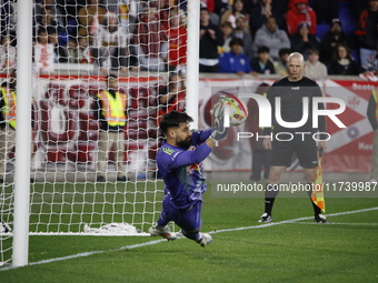 New York Red Bulls goalkeeper Carlos Coronel makes a penalty kick save to eliminate the defending MLS Cup champion Columbus Crew in Harris,...